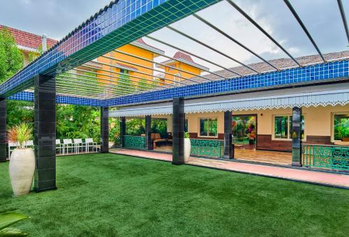 an external view of a house with a lawn at MAYFAIR Lake Resort in Raipur