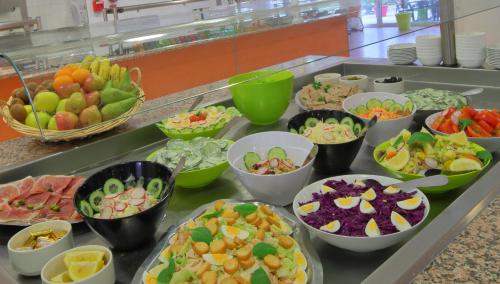 a buffet with many bowls of different types of food at Hotel CIS Paris Kellermann in Paris