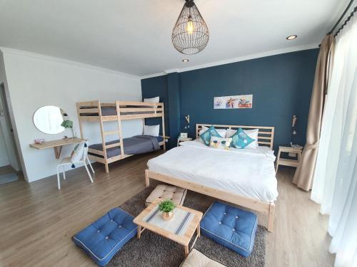 a bedroom with a bed and a bunk bed at Thira House in Karon Beach