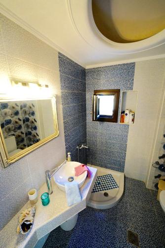 a bathroom with a sink and a toilet at Apartment Vana in Metamorfosi