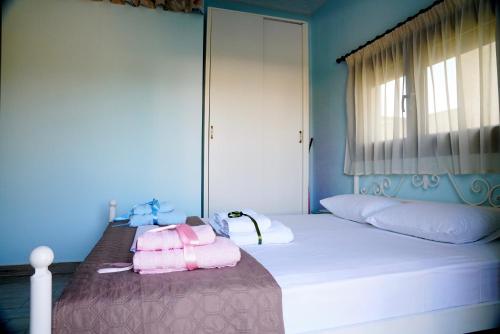 a bedroom with a bed with two towels on it at Apartment Vana in Metamorfosi