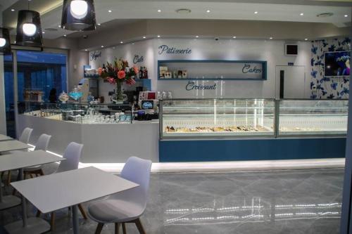a restaurant with tables and chairs in front of a bakery at B&B Lo Scrigno del Salento in Sava