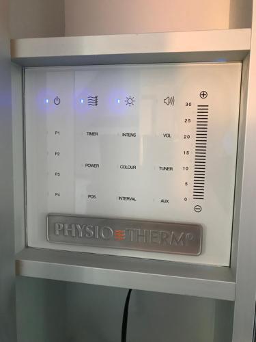 a microwave oven with a digital clock on it at Wieko Ferienwohnungen - Luxus Pur im Prinz von Preußen in Bad Elster