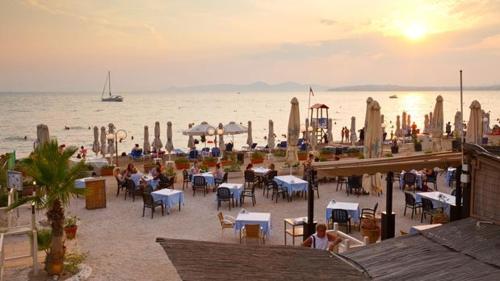 a group of tables and chairs on a beach at SEASIDE SUNSET WALKS in Athens