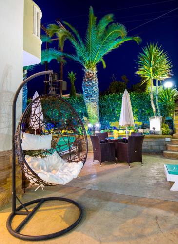 a swing in the middle of a patio at night at Garden in Limenaria