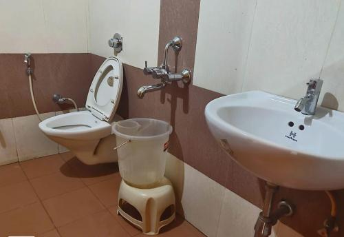 a bathroom with a toilet and a sink at Rainwood Residency in Lonavala