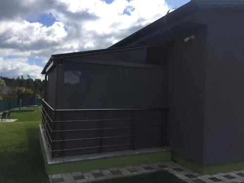 a black building with a window on the side of it at Apartmán Pod Klinom in Pribylina