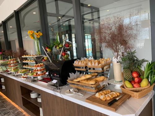 a buffet with bread and other foods on a table at DQua Hotel in Nha Trang