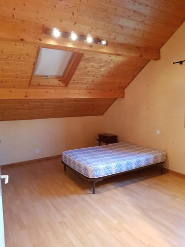 a bedroom with a bed in a attic at Gîte Micha in Saint-Lothain