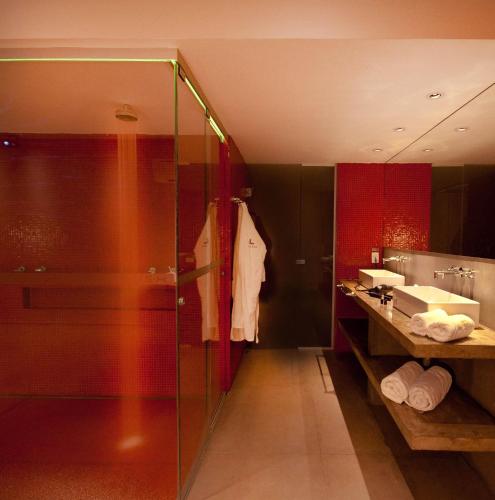 a bathroom with a glass shower and a sink at Lush Motel Ipiranga in Sao Paulo