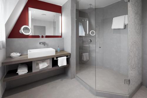 a bathroom with a sink and a shower at Best Western Plus Arosa Hotel in Paderborn