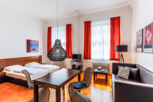 a living room with a couch and a table at ABC Hotel in Konstanz