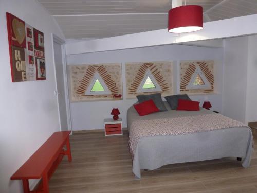 a bedroom with a bed and two windows at Domaine de calbiac in Dolmayrac