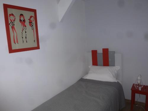 a bedroom with a bed and a picture on the wall at Domaine de calbiac in Dolmayrac