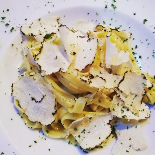 a plate of pasta with chicken and cheese at Podere La Paolina in Montefollonico