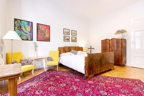 a bedroom with a bed and a red rug at At the Three Princes in Brno