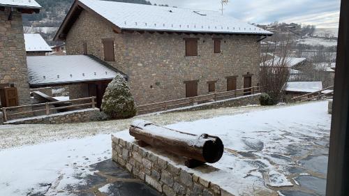 a large brick building with snow on the ground at Can Marc de Pi, Bellver de Cerdanya in Pi
