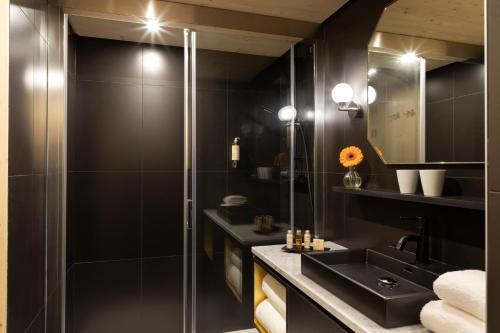 a bathroom with a sink and a mirror at St-Alban Hotel & Spa in La Clusaz