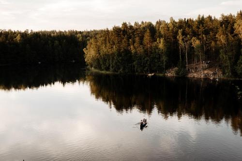 a person in a boat in the middle of a lake at Lapland Hotels Bulevardi in Helsinki