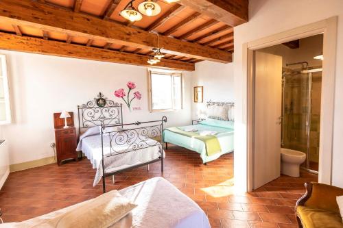 a bedroom with a bed and a shower in a room at Agriturismo La Mignola in Quercianella