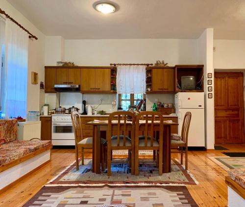 a kitchen and dining room with a table and chairs at Πέτρινο παραδοσιακό σπίτι "Χιονάτη" in Nimfaíon