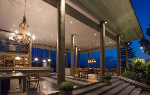 a dining area on a building with a chandelier at Sirinati Khao Kho in Khao Kho