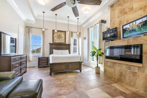 a living room with a bed and a tv at Spacious 4BR Condo on Carondelet Near All Hot Spo in New Orleans