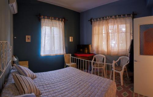 a bedroom with a bed and a table and chairs at VILA INSPIRATION - ON KINI BEACH in Kinion