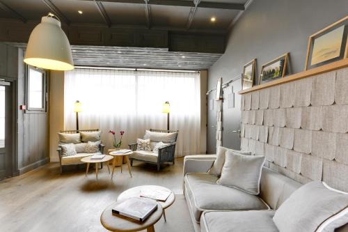 a living room with a couch and a table at Le Faucigny - Hotel de Charme & SPA in Chamonix-Mont-Blanc