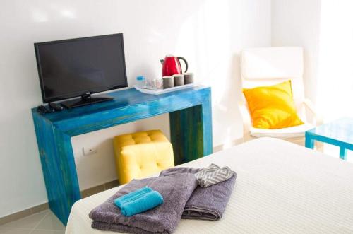a room with a bed with a tv and a fireplace at Art Villa Dominicana in Punta Cana