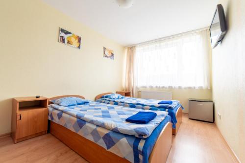 Postel nebo postele na pokoji v ubytování SportHotel