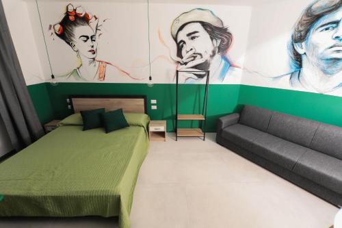 a bedroom with a green bed and a couch at O.Effe. Suites / Vatican in Rome