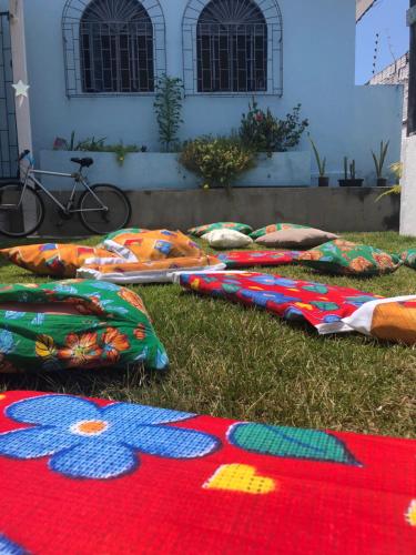 a group of blankets laying on the grass at Hostel Das Canárias in Natal