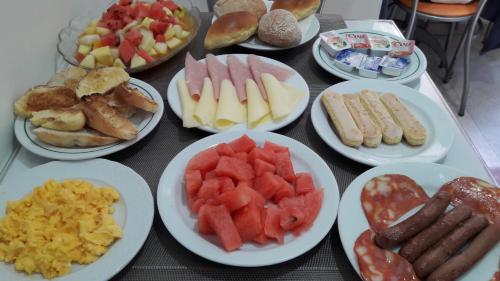 a table topped with plates of different types of food at Hotel Alicante Lisboa in Lisbon