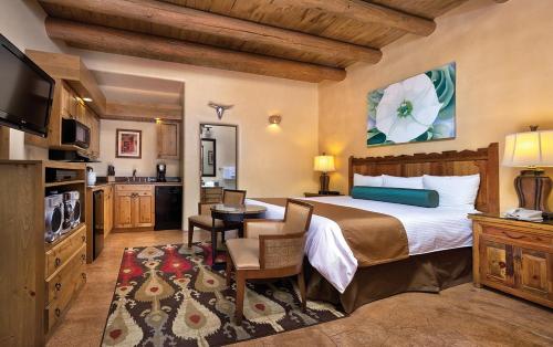 a bedroom with a large bed and a kitchen at WorldMark Santa Fe in Santa Fe