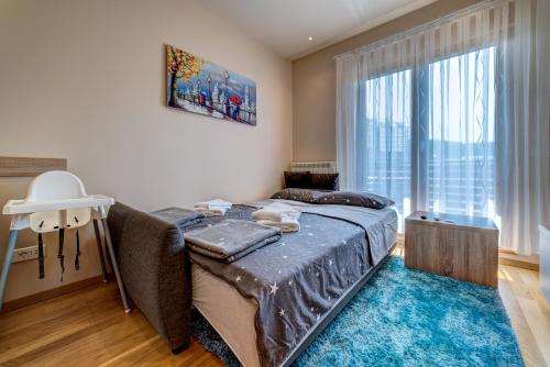a bedroom with a bed and a large window at Hill Spa in Zlatibor