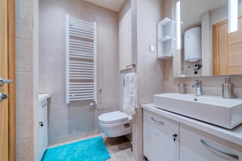 a bathroom with a white sink and a toilet at Hill Spa in Zlatibor