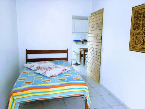 a bedroom with a bed with a colorful blanket on it at Solar Dona Maria in Pinheira