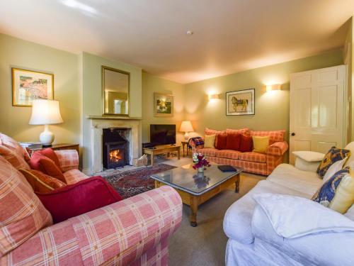 a living room with two couches and a fireplace at Bellhouse in Stonehouse