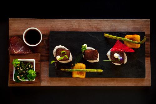 a plate of food on a table with sushi at De Kombuys in Oudtshoorn