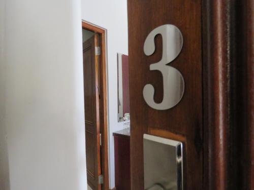 a bathroom door with a number thirty three on it at Abiento Guesthouse in Bloemfontein