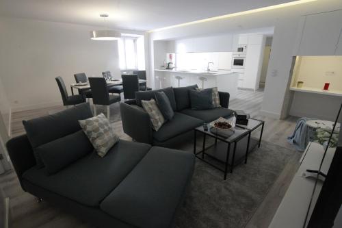 a living room with a couch and a table at Apartamento das Malheiras in Viana do Castelo