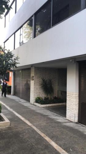 a man standing in front of a building at Suite G Mancera in Mexico City