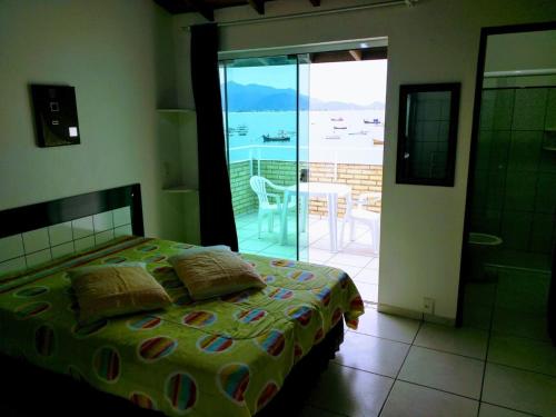 a bedroom with a bed and a view of the ocean at Solar Dona Maria in Pinheiro