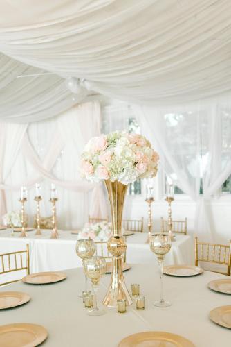 a table with a vase of flowers on it at Georgia Palms & Gardens in Powder Springs