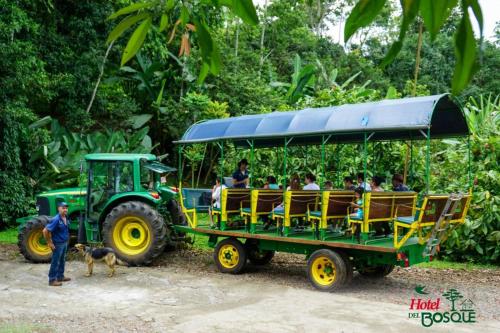a group of people riding on the back of a tractor at Hotel del Bosque in Río Cuarto