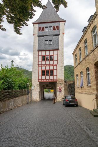 a large red and white building on a street at Altkölnischer Hof in Bacharach