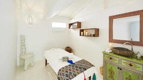 a bedroom with a bed and a mirror and a sink at PK25 Dakhla in Dakhla