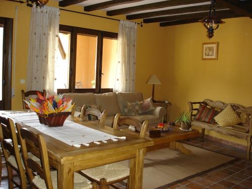 a living room with a table and a couch at CASA RURAL CASA CANDI in El Arenal