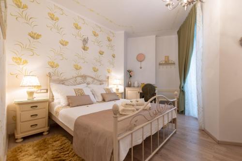 a bedroom with a bed with a floral wallpaper at Unique Luxury Rooms in Split
